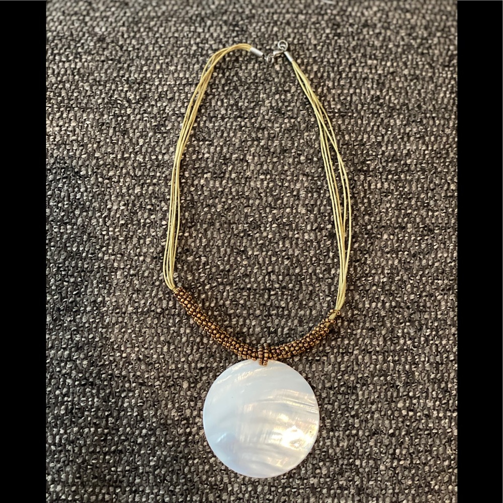 Gold necklace with shell adornment